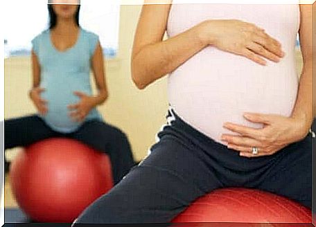 Pregnant women sitting on a fitness ball