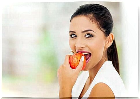 Woman eats an apple