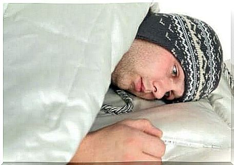 A man is sick in bed with a hat on