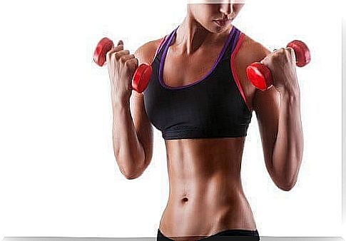 Woman training with weights for beautiful, toned arms