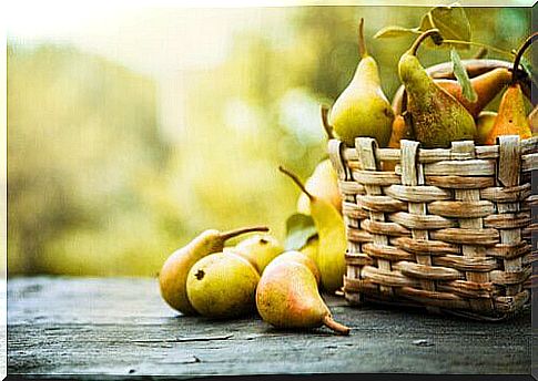 Pears in a basket and loose on the table