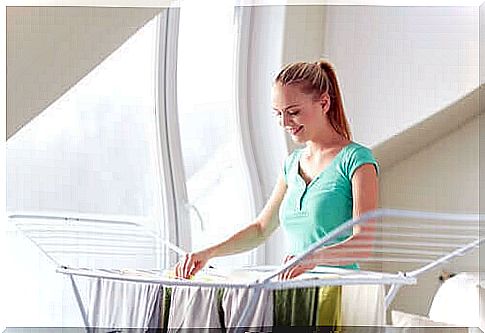 A woman hangs the laundry on a drying rack