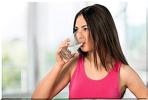 Woman drinks a glass of water